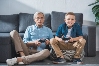 Grandfather and grandson playing video games
